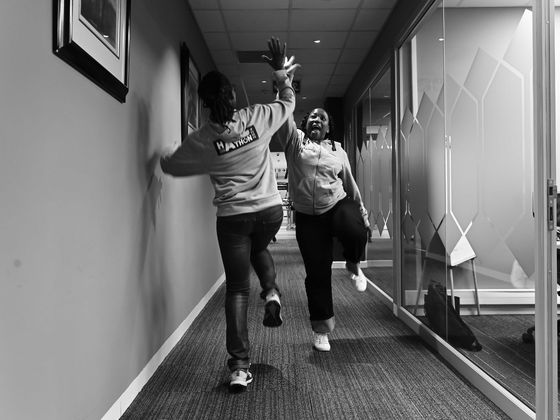 Hackathon participants celebrating in a corridor